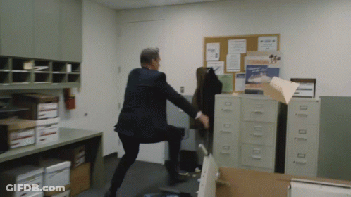 Man In Suit Kicking Chair With Mickey Mouse Picture GIF