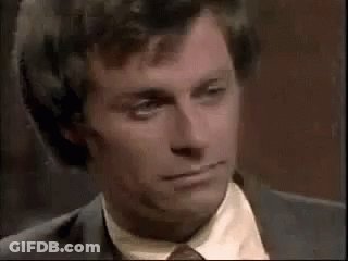 Man In Suit Kissing Another Man GIF