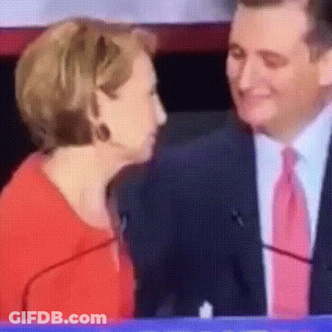 Man In Suit Kissing Woman In Red Shirt GIF