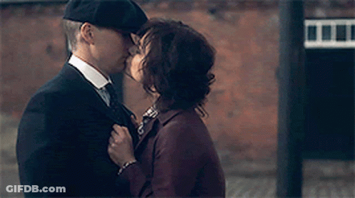 Man In Suit Kissing Woman On Cheek GIF