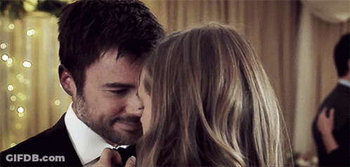 Man In Suit Kissing Woman's Forehead GIF