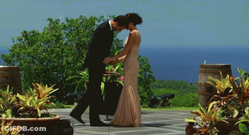 Man In Suit Kissing Woman's Forehead GIF