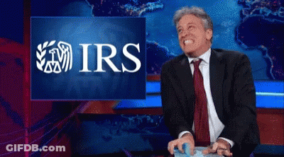 Man In Suit Laughing At IRS Screen GIF