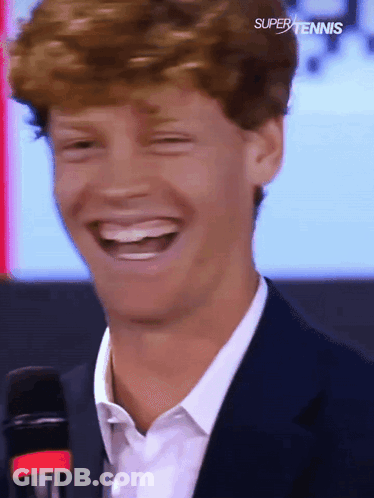 Man In Suit Laughing At Super Tennis Logo GIF