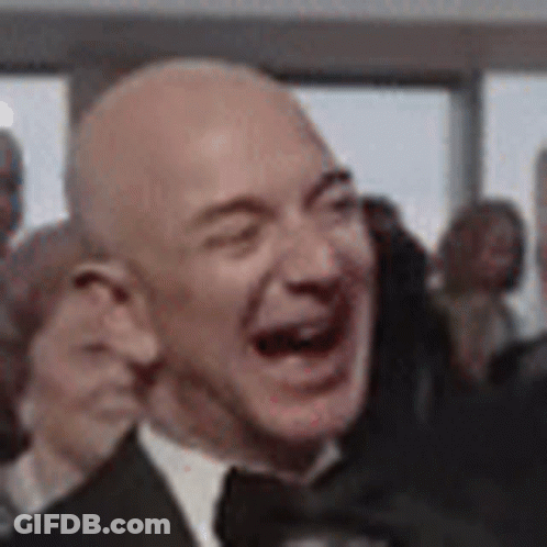 Man In Suit Laughing Eyes Closed In Crowd GIF