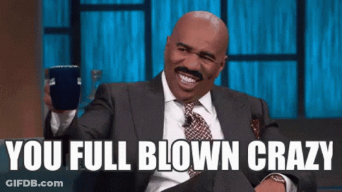 Man In Suit Laughing Holding Cup Saying You Full Blown Crazy GIF