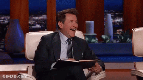 Man In Suit Laughing Holding Notebook GIF