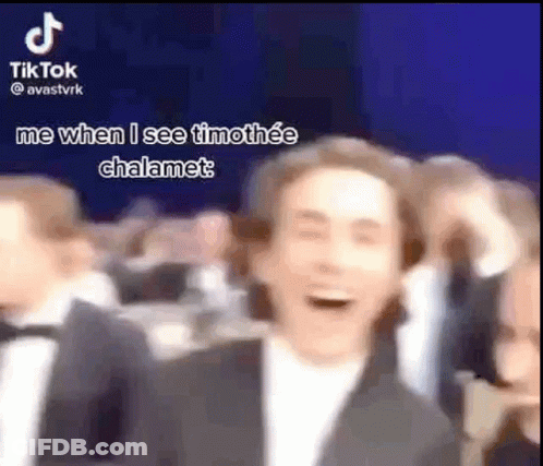 Man In Suit Laughing In Crowd GIF