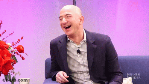 Man In Suit Laughing In Front Of Business Insider Banner GIF