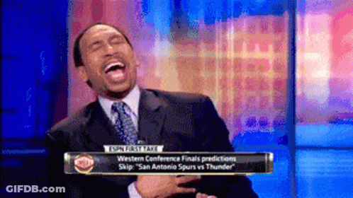 Man In Suit Laughing In Front Of ESPN Sign GIF