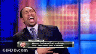 Man In Suit Laughing In Front Of Sports Talk Sign GIF