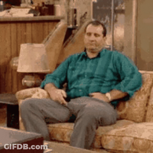 Man In Suit Laughing In Hallway GIF