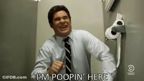Man In Suit Laughing Next To Toilet Paper GIF