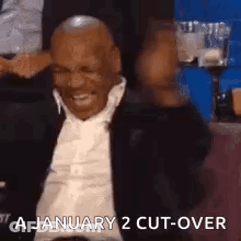 Man In Suit Laughing With Arms Up GIF