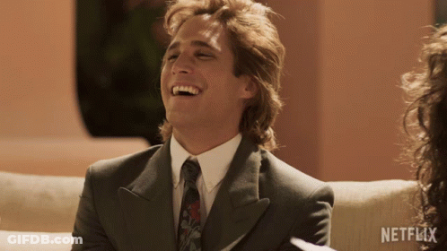 Man In Suit Laughing With Netflix Logo GIF