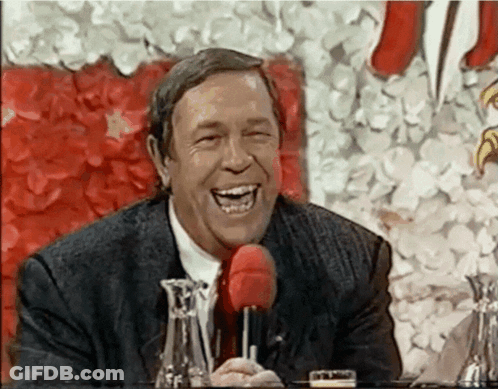 Man In Suit Laughing With Red Microphone GIF