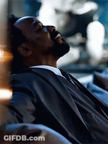 Man In Suit Laying On Couch Eyes Closed GIF