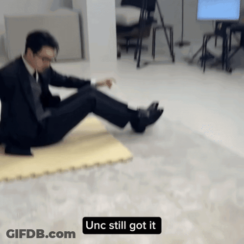 Man In Suit Laying On Floor Unc Still Got It GIF