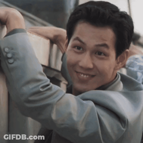 Man In Suit Leaning Against Wall GIF