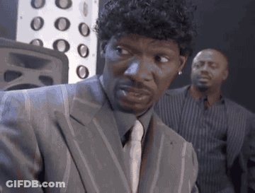 Man In Suit Looking At Camera With Another Man Behind GIF