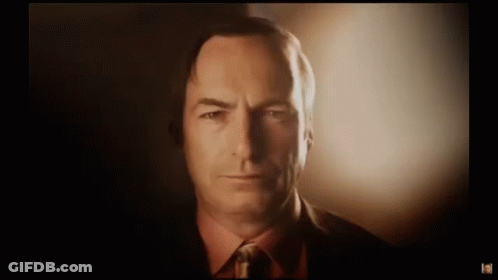 Man In Suit Looking At Camera With Glowing Light GIF