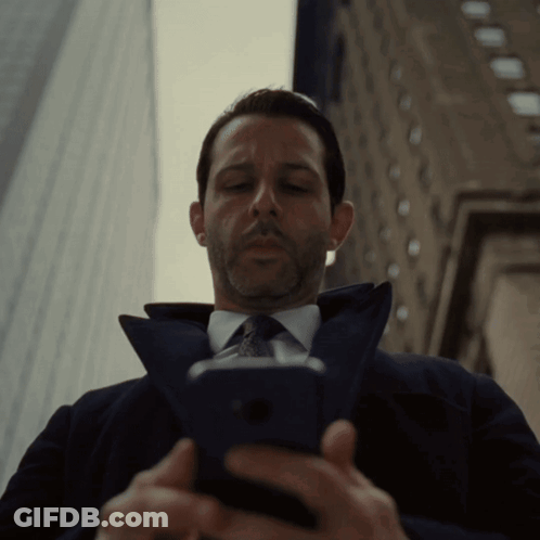 Man In Suit Looking At Cell Phone GIF