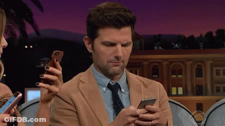 Man In Suit Looking At Cell Phone GIF