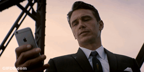 Man In Suit Looking At IPhone GIF