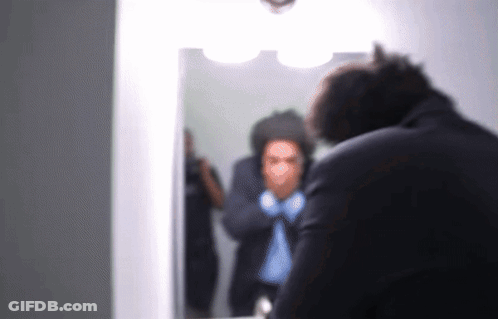 Man In Suit Looking At Mirror GIF