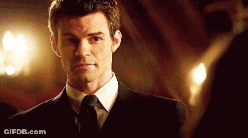 Man In Suit Looking At Mirror GIF