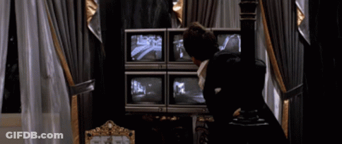 Man In Suit Looking At Monitors Says You Wanna Play Games GIF