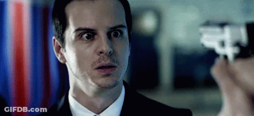 Man In Suit Looking At Person Holding Gun GIF
