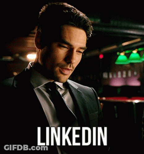 Man In Suit Looking At Phone LinkedIn GIF