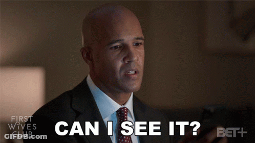 Man In Suit Looking At Phone Saying Can I See It GIF
