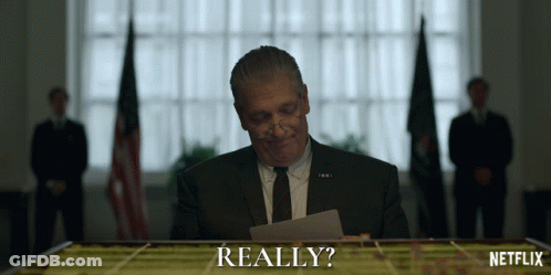 Man In Suit Looking At Really Paper GIF