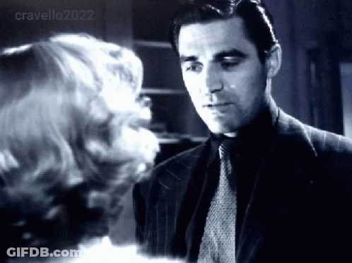Man In Suit Looking At Woman In Black And White Photo GIF