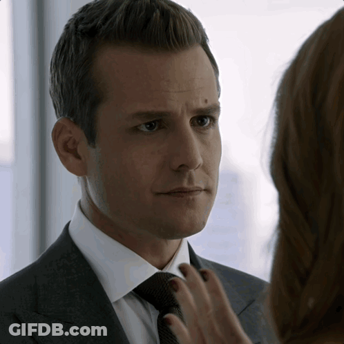 Man In Suit Looking At Woman's Hand GIF