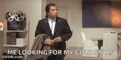 Man In Suit Looking For Gold Stars GIF