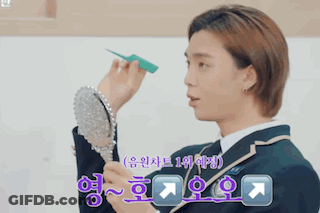 Man In Suit Looking In Mirror With Chinese Writing GIF
