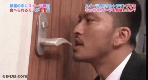 Man In Suit Looking Through Door Handle With Chinese Writing GIF