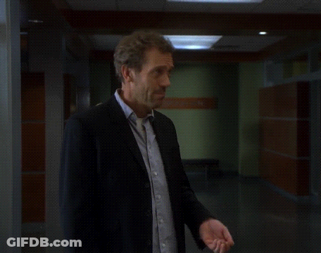 Man In Suit Looking Up In Hallway GIF