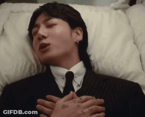 Man In Suit Lying In Coffin GIF