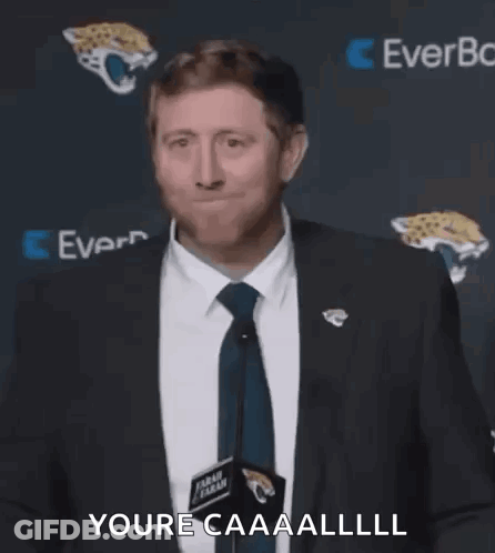 Man In Suit Making Face At Microphone GIF