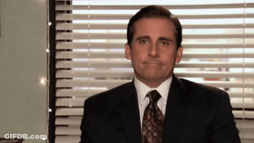 Man In Suit Making Face At Window With Blinds GIF