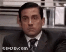 Man In Suit Making Funny Face At Desk GIF