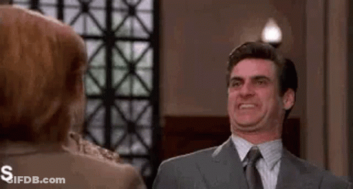 Man In Suit Making Funny Face At Woman GIF