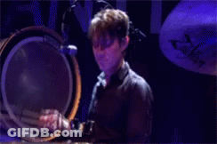 Man In Suit Making Funny Face Before Skyline GIF