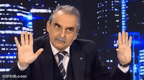 Man In Suit Making Funny Face By City Skyline GIF