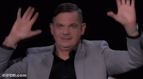 Man In Suit Making Funny Face Hands Up GIF