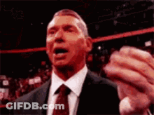 Man In Suit Making Funny Face Holding Something GIF